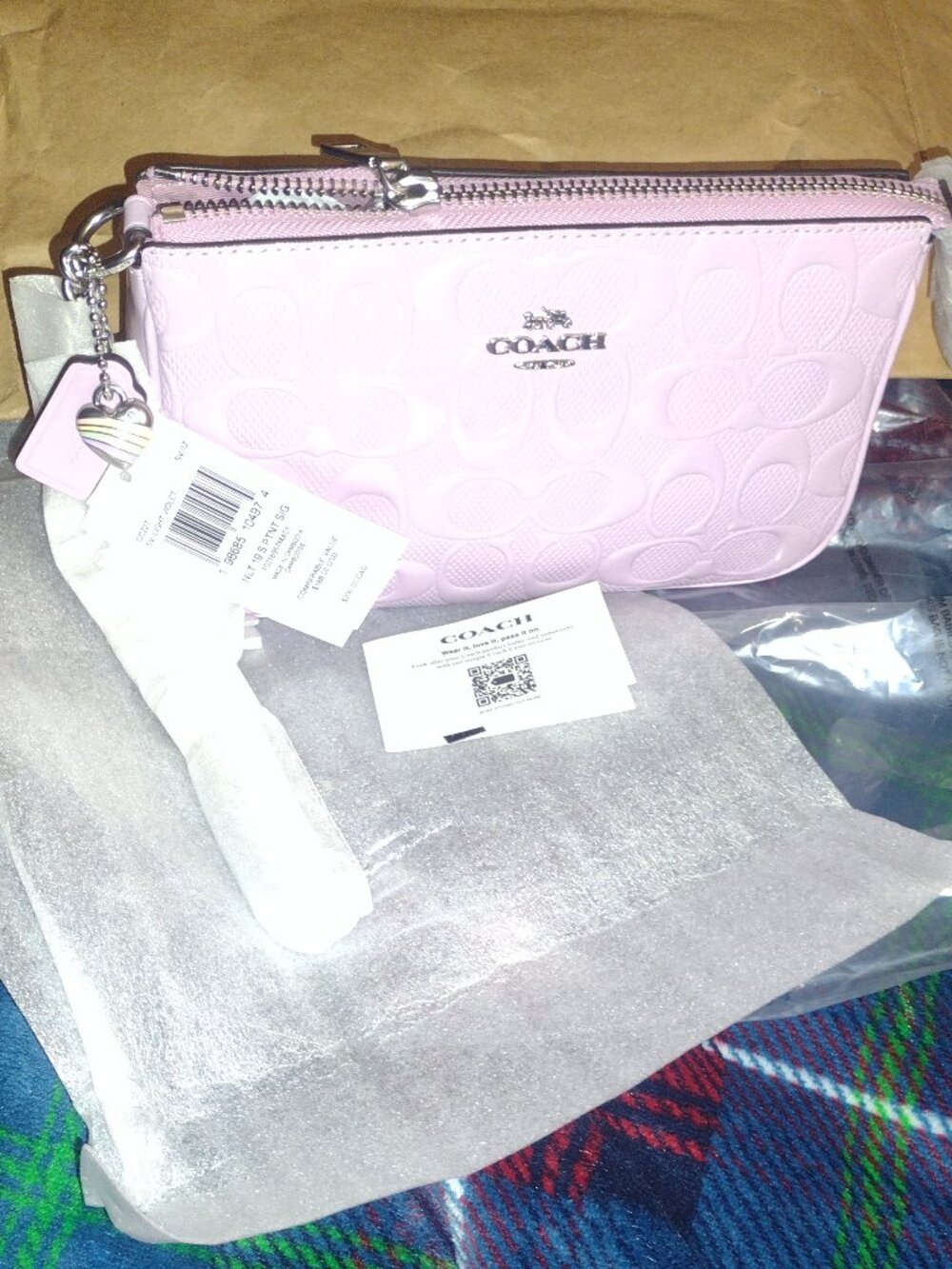 Coach Nolita 19 in signature pearlized leather light violet with heart charm.